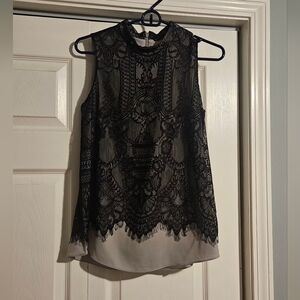 Antonio Melani black lace blouse with a high neckline and lighter gray underlay